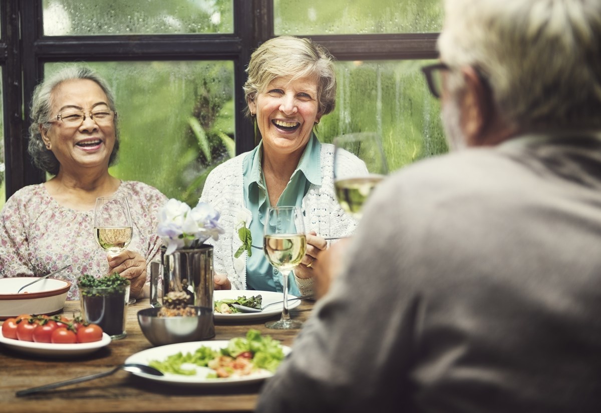 Two women and a man having a meal